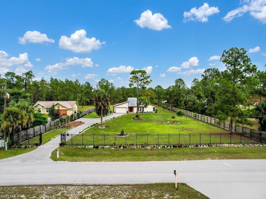 260 12th Street Southeast Naples, FL 34117 - Photo 2 of 29 a view of a house with a yard
