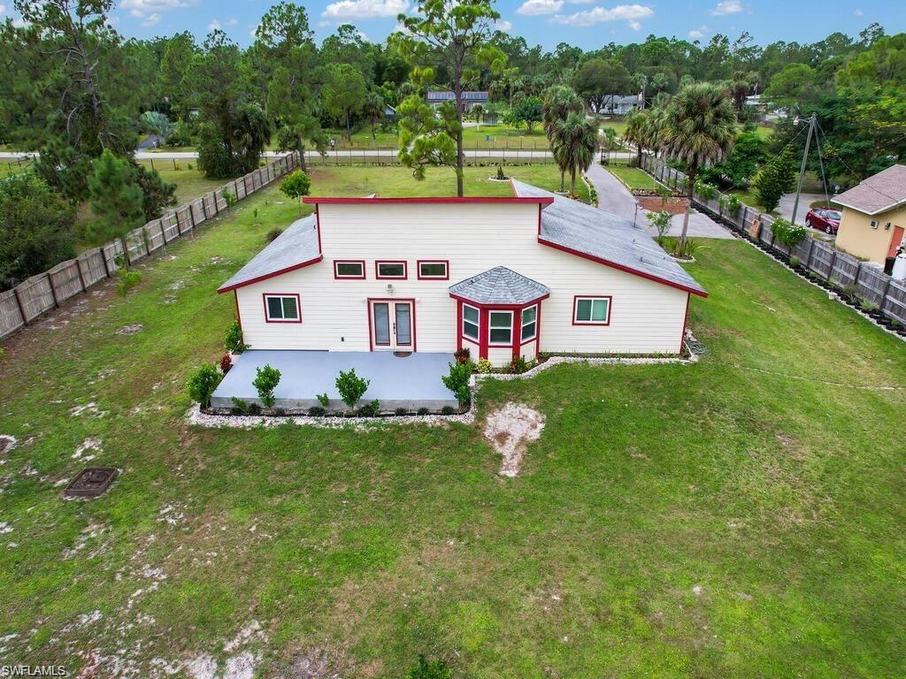 260 12th Street Southeast Naples, FL 34117 - Photo 24 of 29 a view of house with backyard outdoor seating and lake