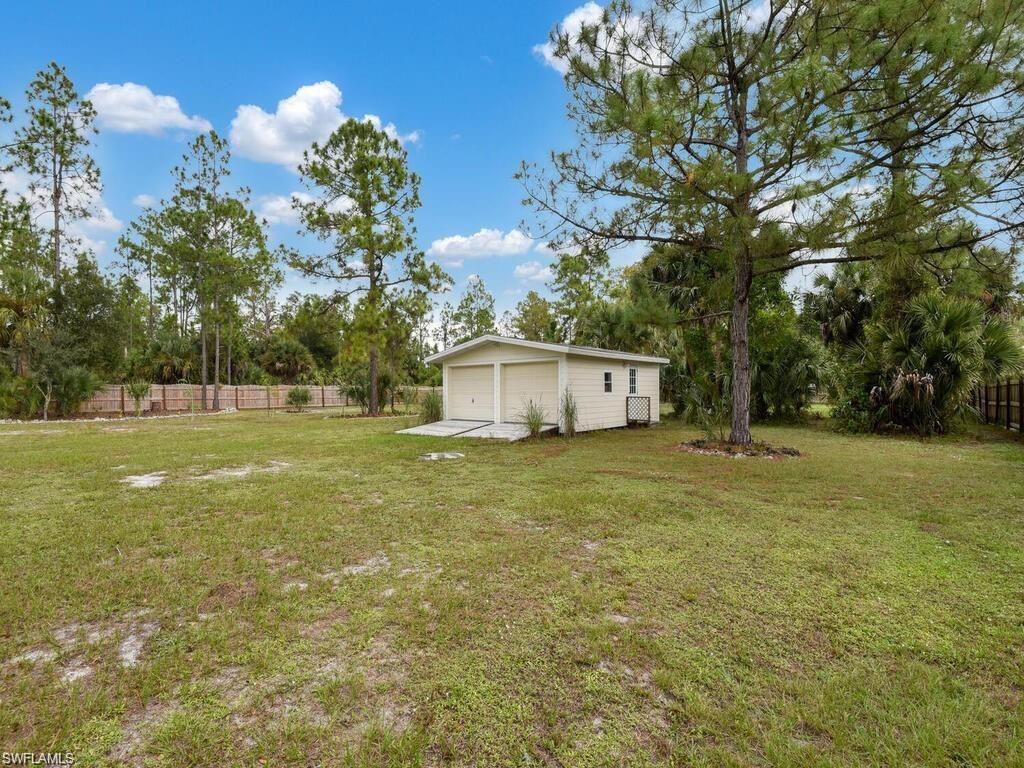 260 12th Street Southeast Naples, FL 34117 - Photo 27 of 29 a house view with a garden space