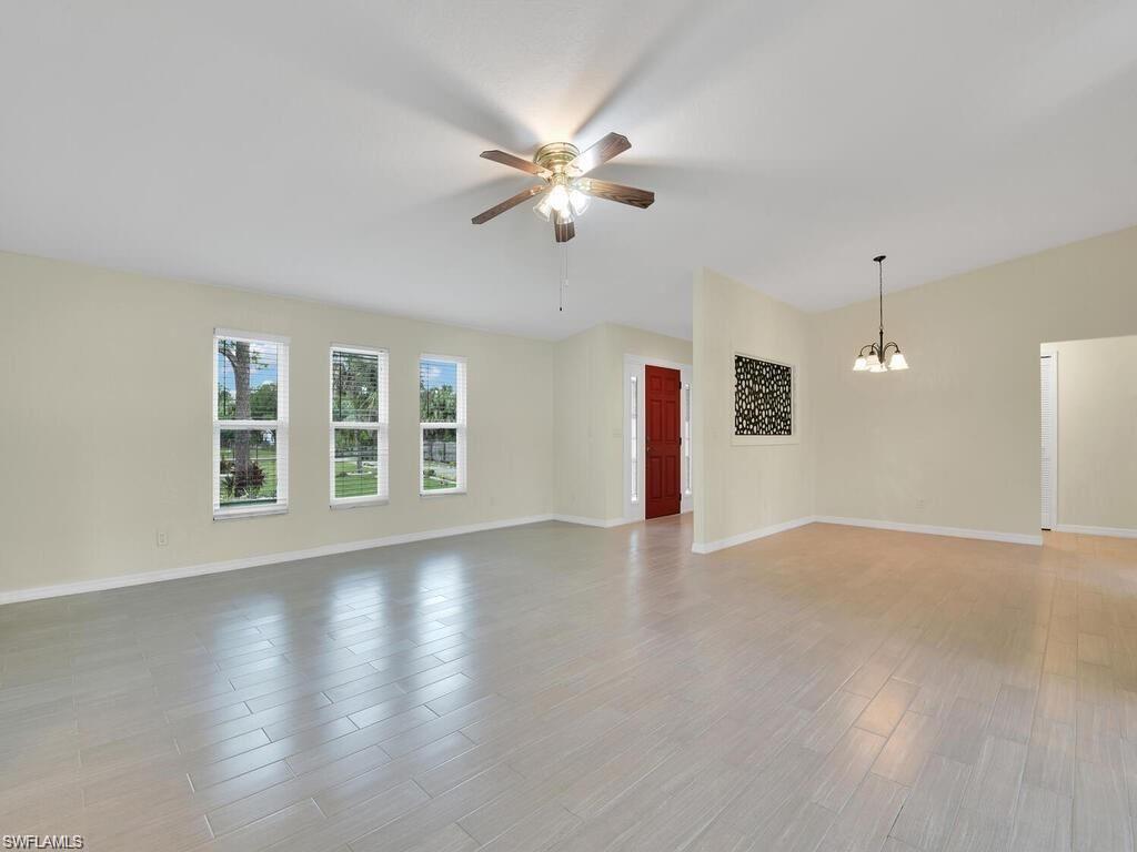 260 12th Street Southeast Naples, FL 34117 - Photo 3 of 29 a view of an empty room with a window and wooden floor