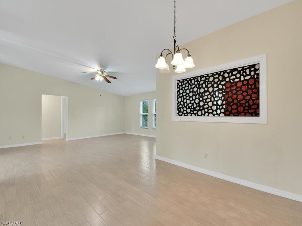 260 12th Street Southeast Naples, FL 34117 - Photo 5 of 29 a view of a livingroom with a chandelier fan and windows