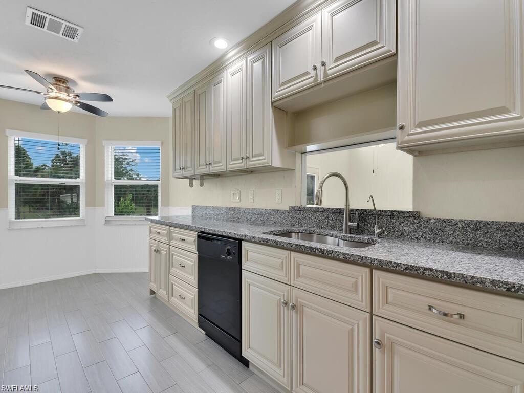260 12th Street Southeast Naples, FL 34117 - Photo 10 of 29 a kitchen with cabinets appliances a sink and a window