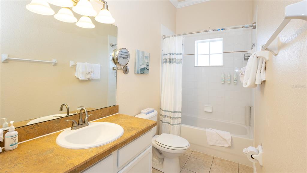 205 Watling Way, Unit 24205 Davenport, FL 33897 - Photo 19 of 58 a bathroom with a sink a toilet and shower