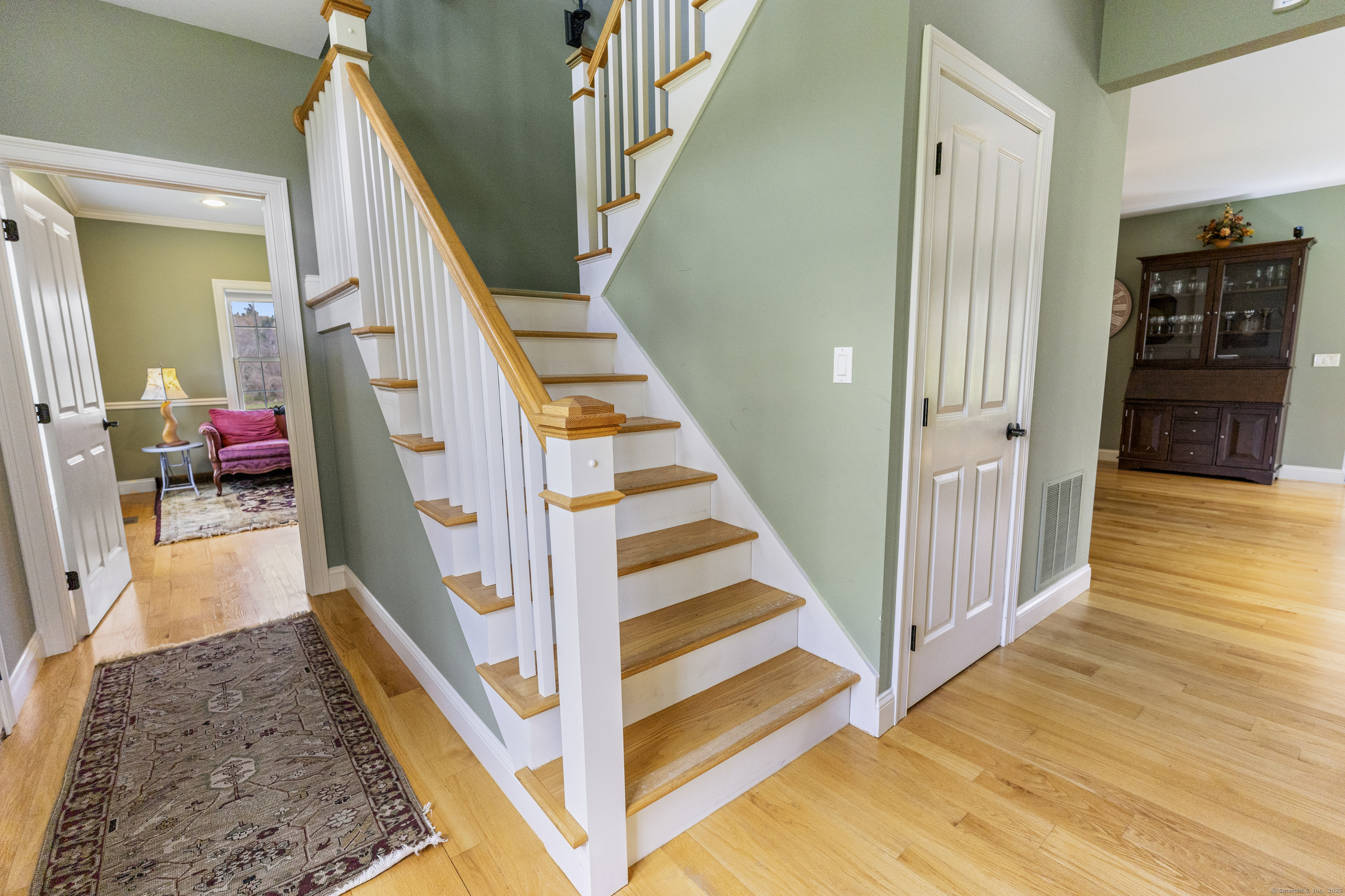 267 Chase Road Thompson, CT 06277 - Photo 14 of 32 a view of a hallway with wooden floor and stairs