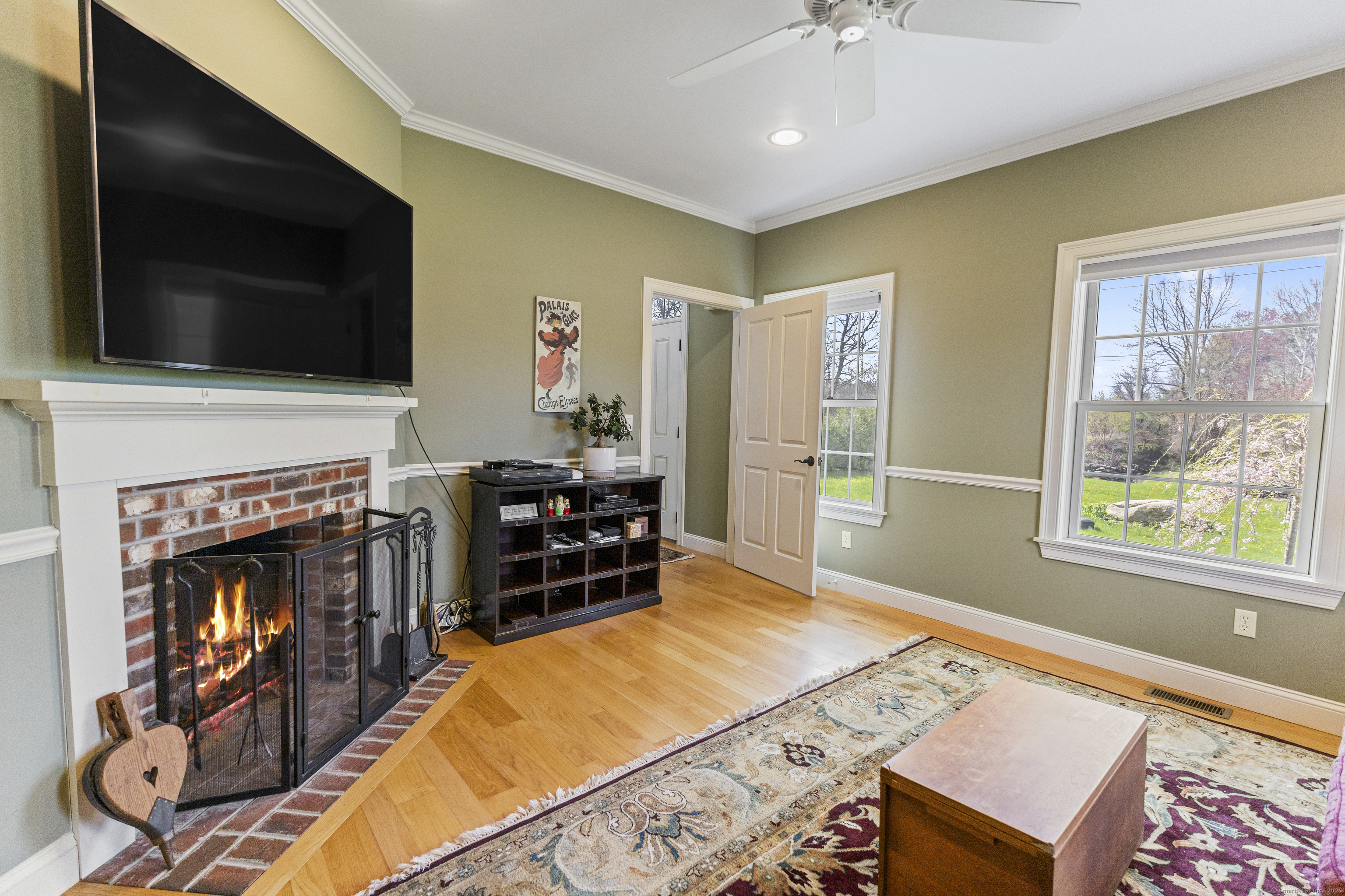 267 Chase Road Thompson, CT 06277 - Photo 16 of 32 a living room with furniture a flat screen tv and a fireplace
