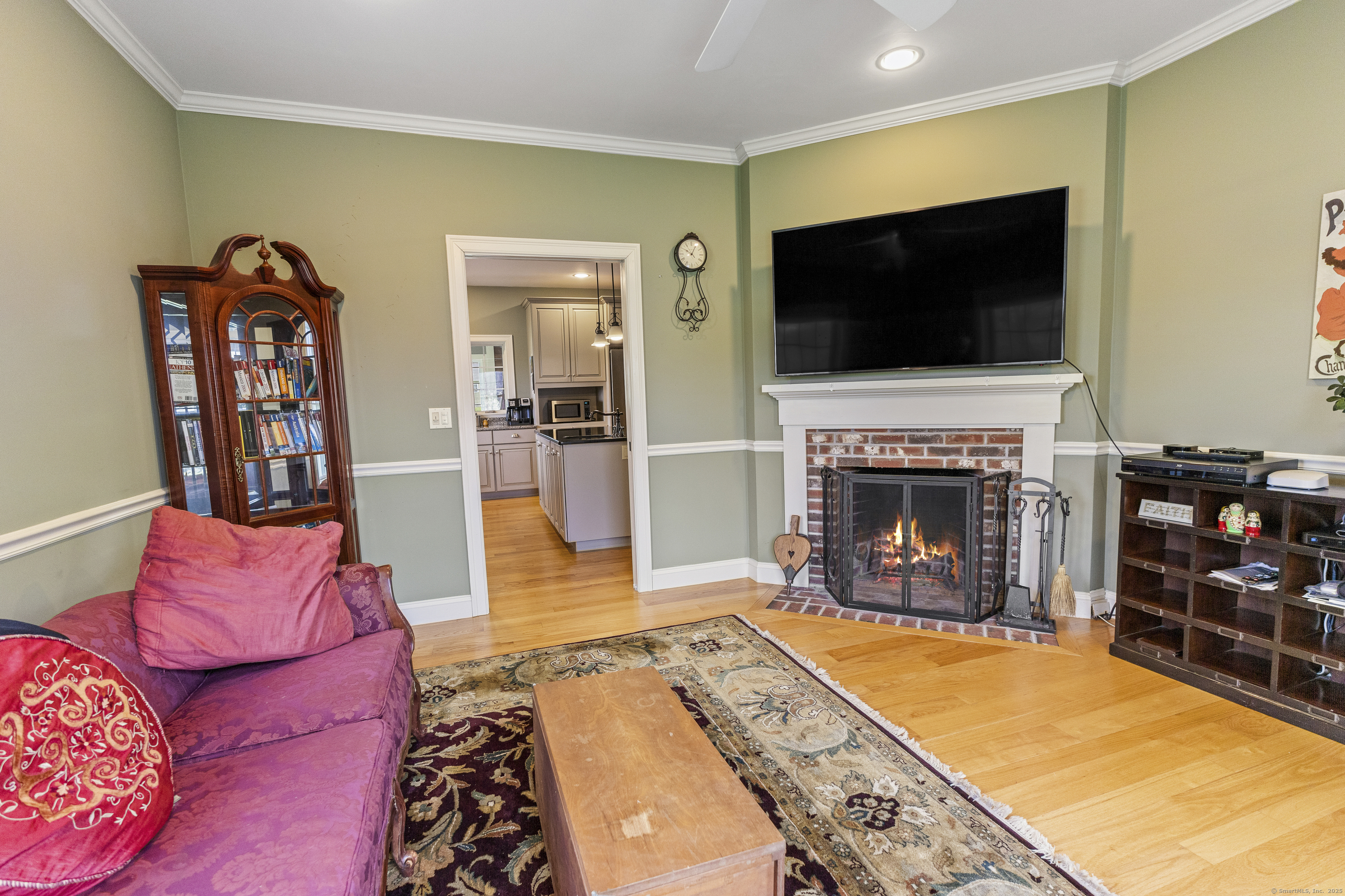 267 Chase Road Thompson, CT 06277 - Photo 17 of 32 a living room with furniture a flat screen tv and a fireplace
