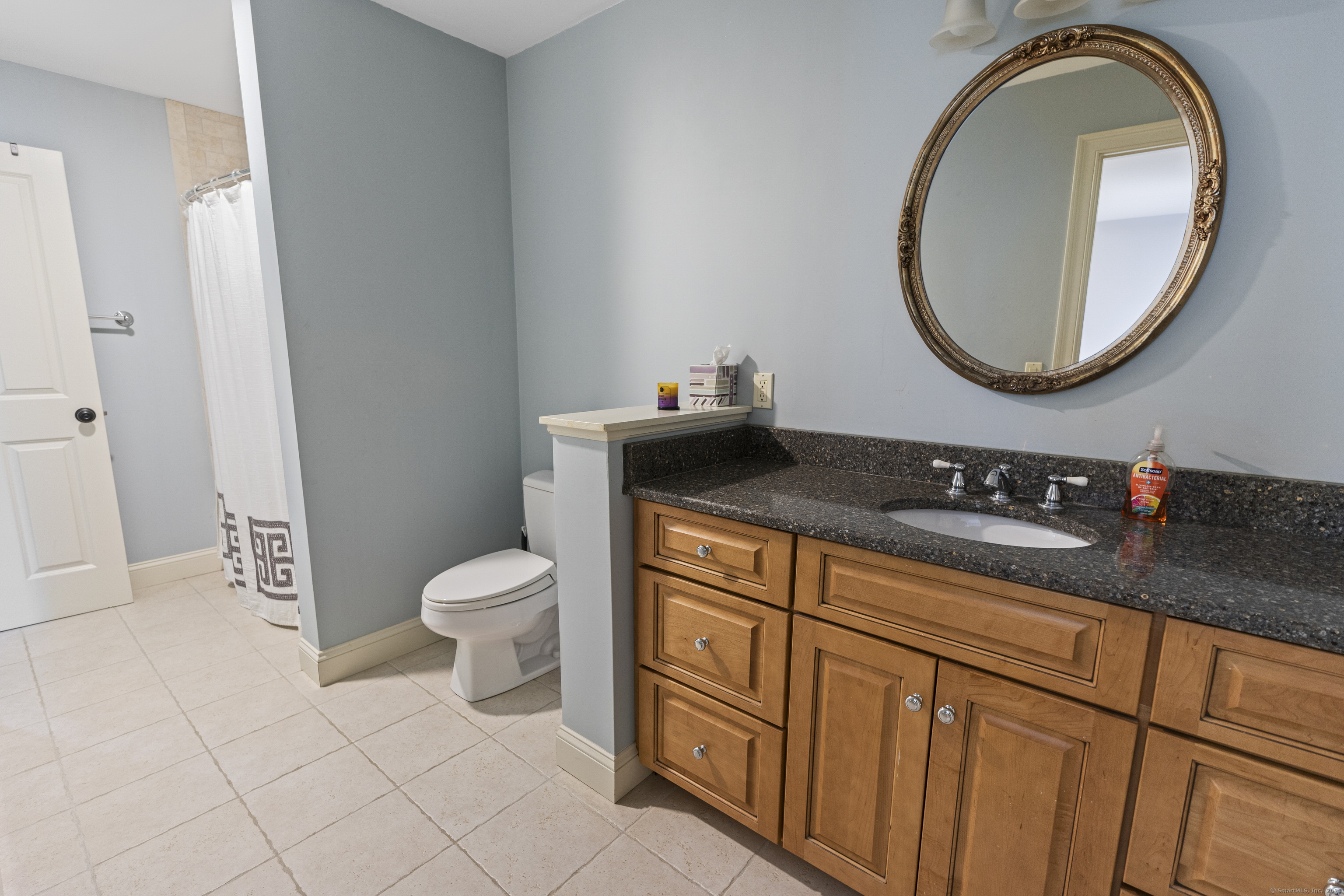 267 Chase Road Thompson, CT 06277 - Photo 20 of 32 a bathroom with a granite countertop toilet a sink and a mirror