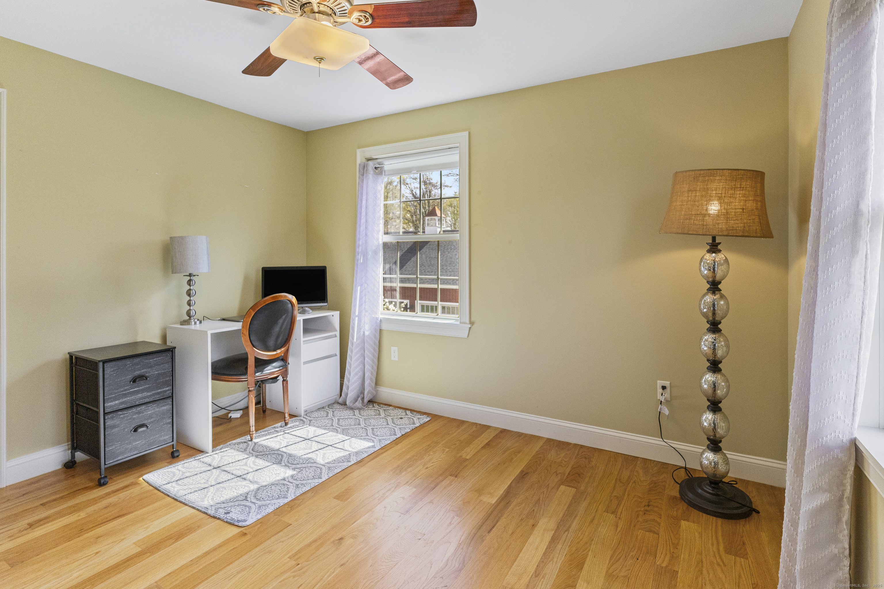 267 Chase Road Thompson, CT 06277 - Photo 21 of 32 a bedroom with a bed and a chandelier