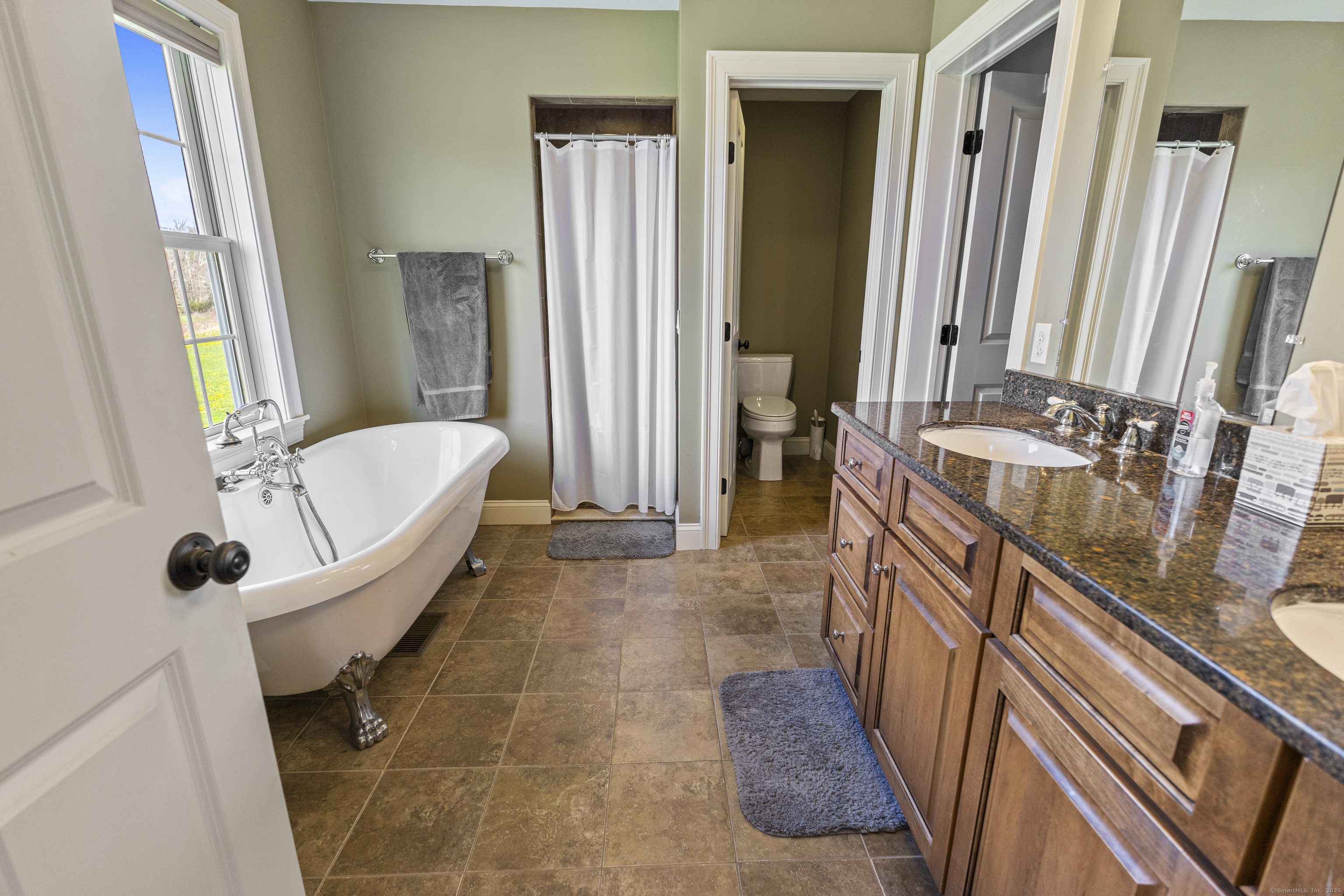 267 Chase Road Thompson, CT 06277 - Photo 23 of 32 a spacious bathroom with a tub a sink and a large mirror
