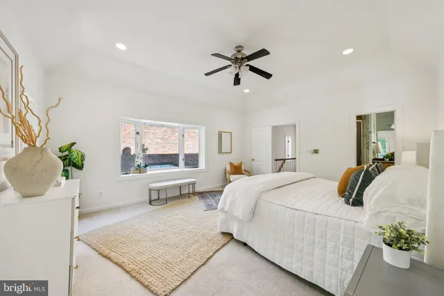a bedroom with a large bed and potted plant