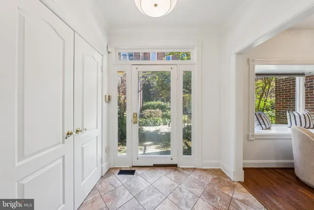 a view of an entryway with wooden floor and windows