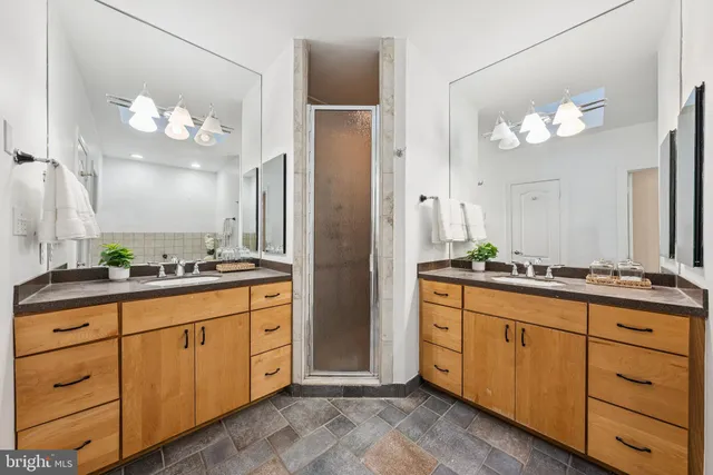 a bathroom with a sink vanity and a mirror
