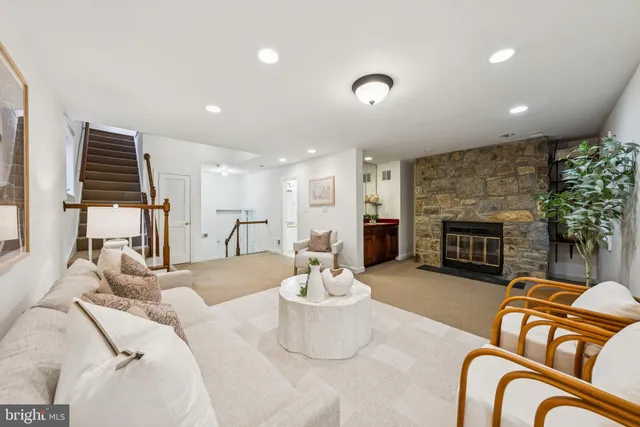 a living room with furniture fireplace and a fireplace