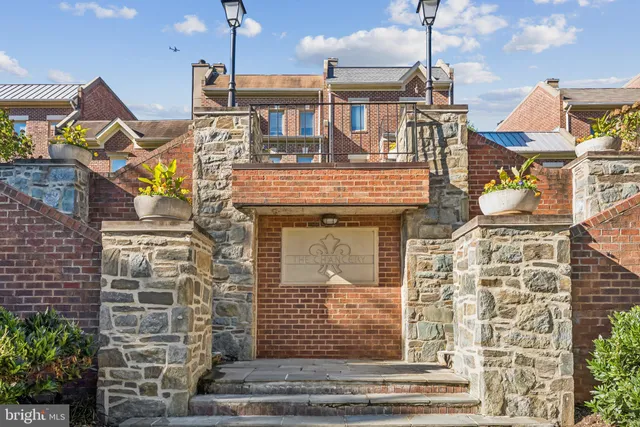 a front view of a building with an entryway and chandelier