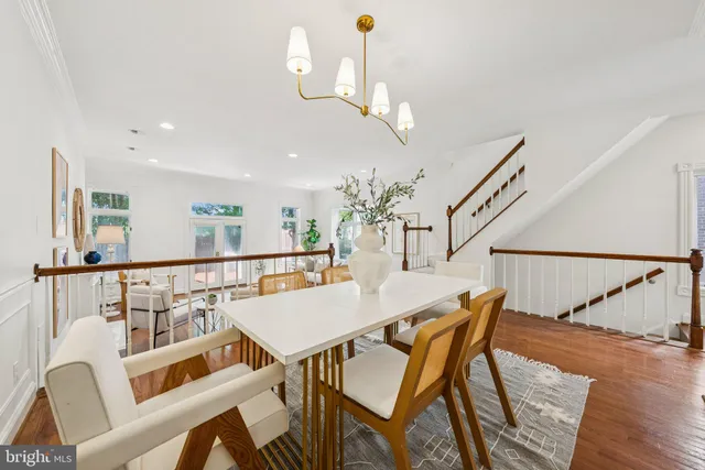 a view of a dining room with furniture wooden floor and chandelier