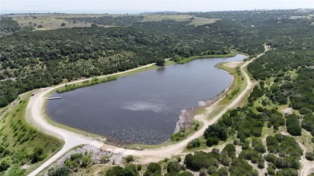 an aerial view of a houses with yard
