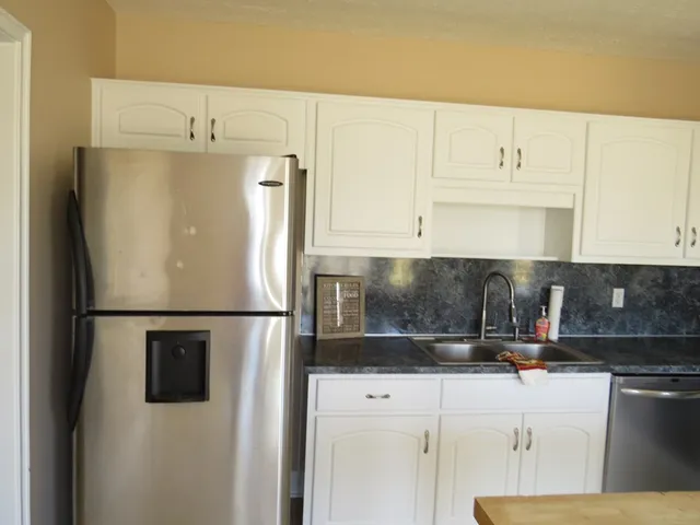 a white refrigerator freezer sitting in a kitchen