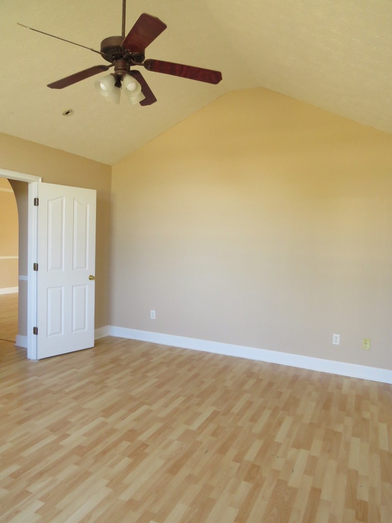 2 Whippoorwill Lane Fort Mitchell, AL 36856 - Photo 23 of 27 a view of room with a ceiling fan and wooden floor