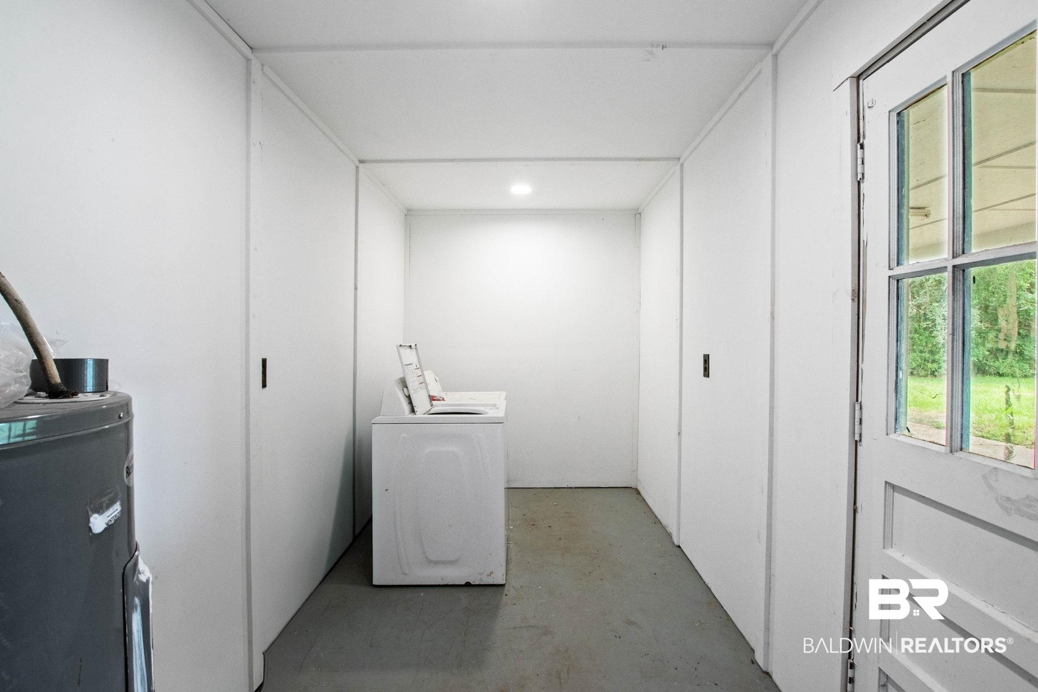 384 Old Bratt Road Atmore, AL 36502 - Photo 51 of 64 Dedicated utility space featuring a white paneled door with glass inserts, recessed lighting, and ample wall space