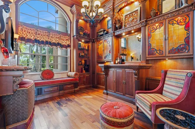 a living room with fireplace furniture and a large window