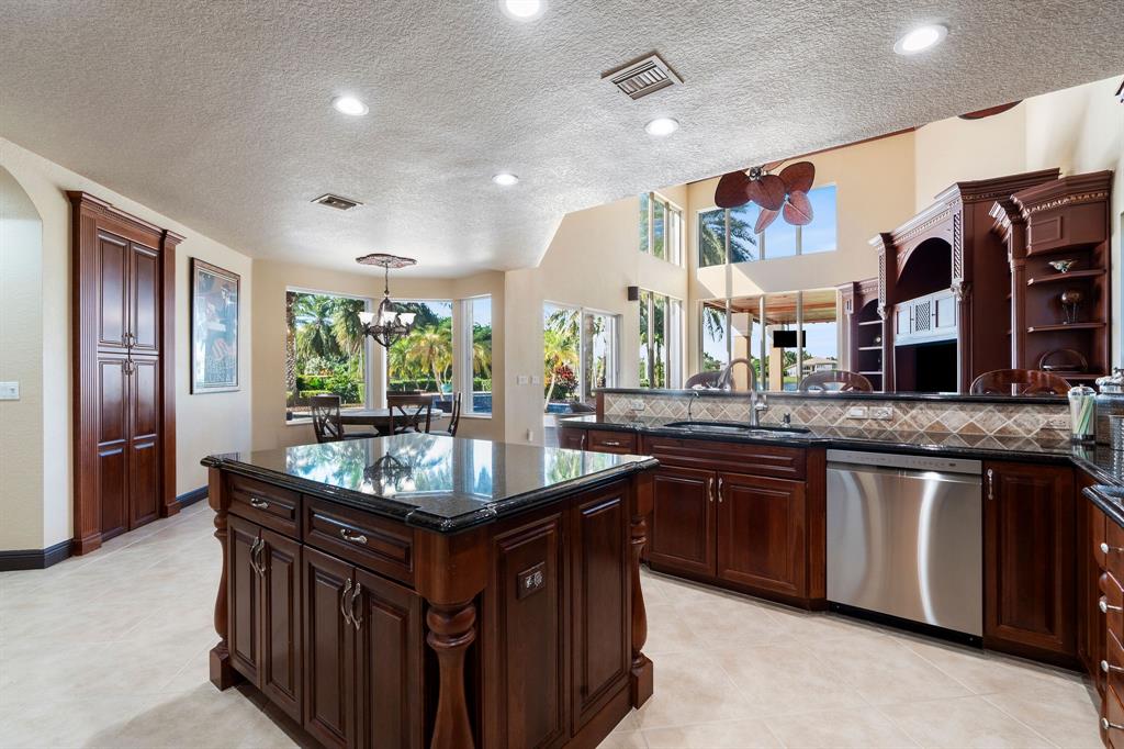 3413 Dovecote Meadow Lane Davie, FL 33328 - Photo 20 of 68 a kitchen with stainless steel appliances granite countertop a sink and a refrigerator
