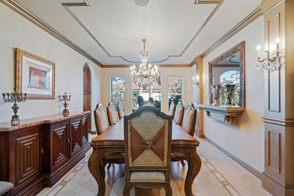 3413 Dovecote Meadow Lane Davie, FL 33328 - Photo 22 of 68 a view of a dining room with furniture and chandelier