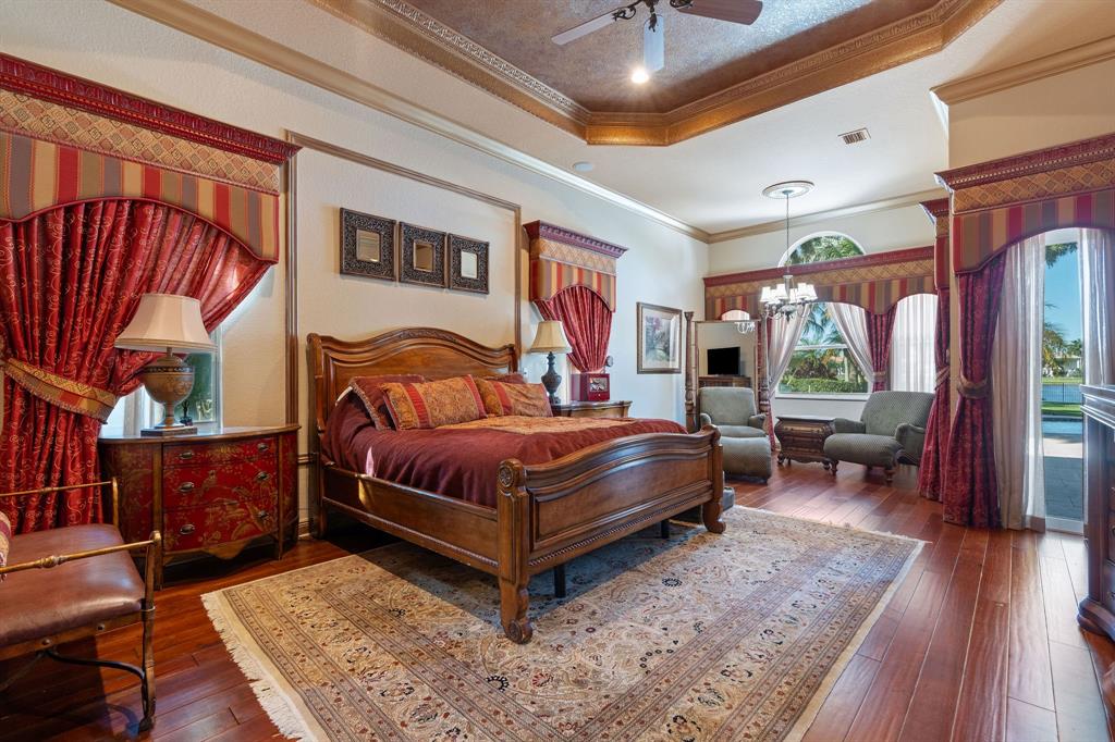 3413 Dovecote Meadow Lane Davie, FL 33328 - Photo 26 of 68 a bedroom with a bed and wooden floor