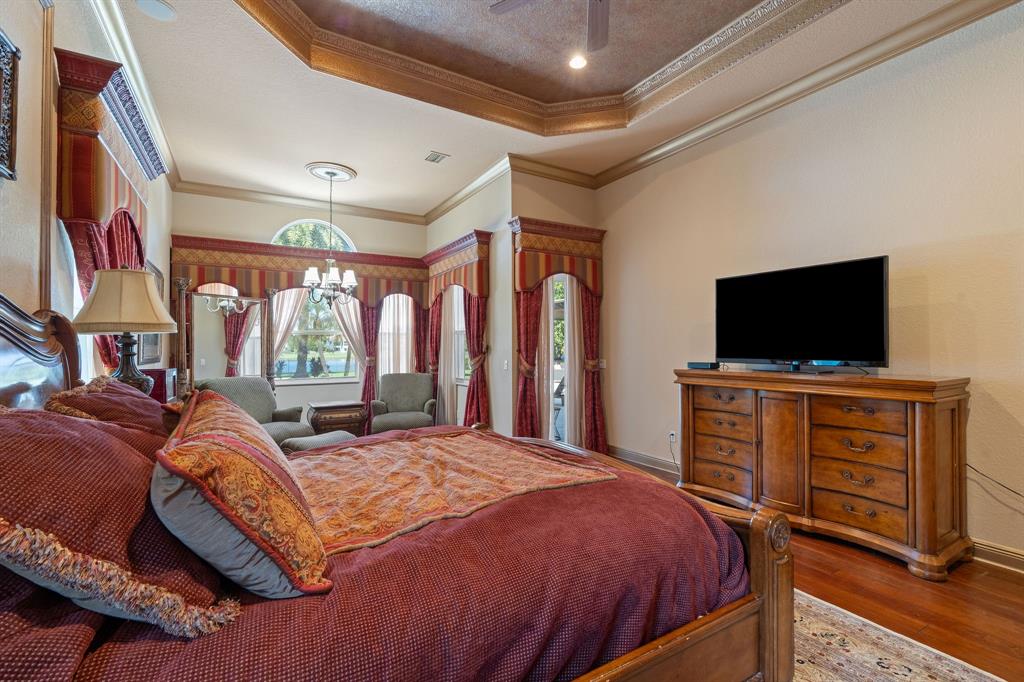 3413 Dovecote Meadow Lane Davie, FL 33328 - Photo 29 of 68 a bedroom with a bed and a flat screen tv