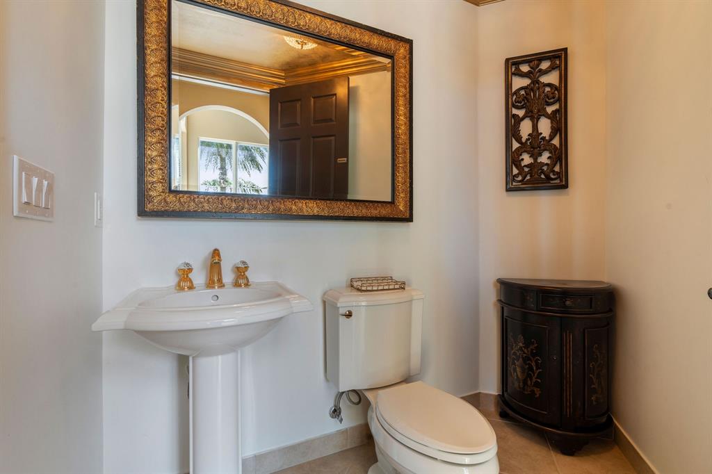 3413 Dovecote Meadow Lane Davie, FL 33328 - Photo 34 of 68 a bathroom with a toilet a sink and mirror