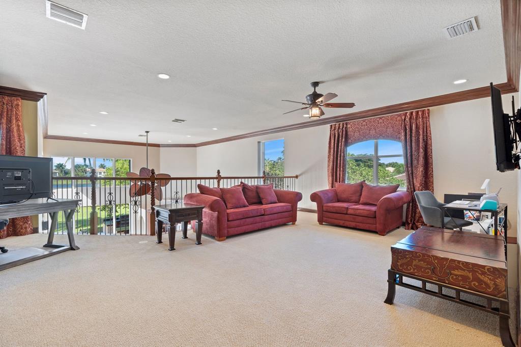 3413 Dovecote Meadow Lane Davie, FL 33328 - Photo 39 of 68 a living room with furniture a ceiling fan and a rug