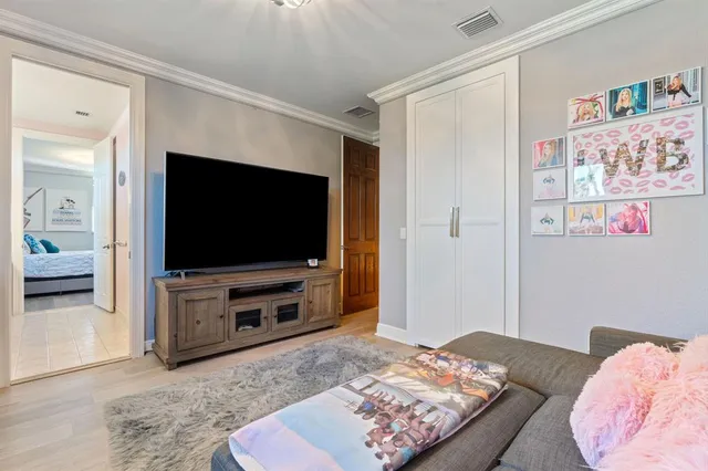 a living room with furniture and a ceiling fan
