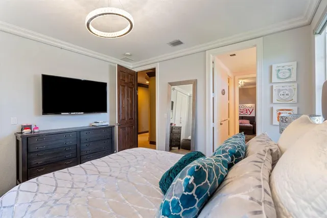 a view of a patio with couches chairs potted plants and floor to ceiling window