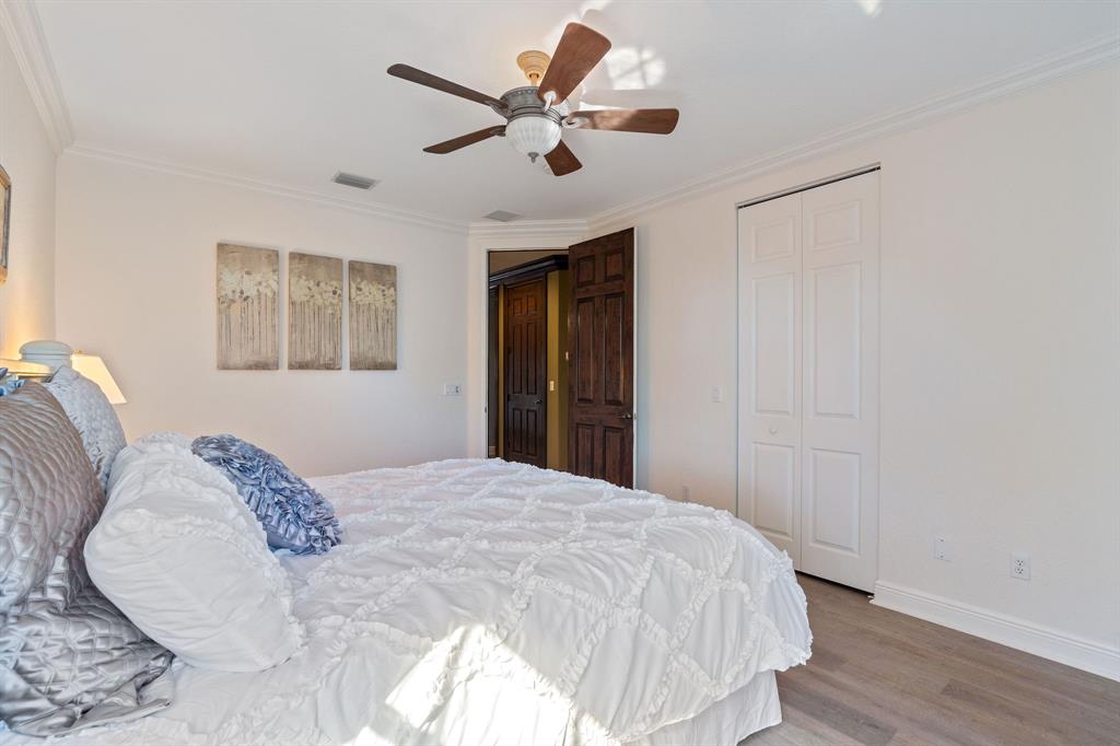 3413 Dovecote Meadow Lane Davie, FL 33328 - Photo 49 of 68 a bedroom with a bed and a chandelier