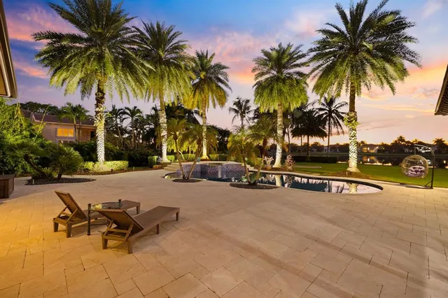 a view of a swimming pool with outdoor seating