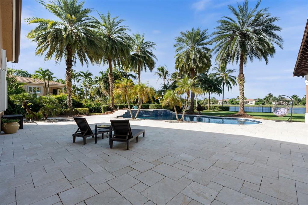 3413 Dovecote Meadow Lane Davie, FL 33328 - Photo 55 of 68 a row of palm trees and swimming pool in the patio of a swimming pool