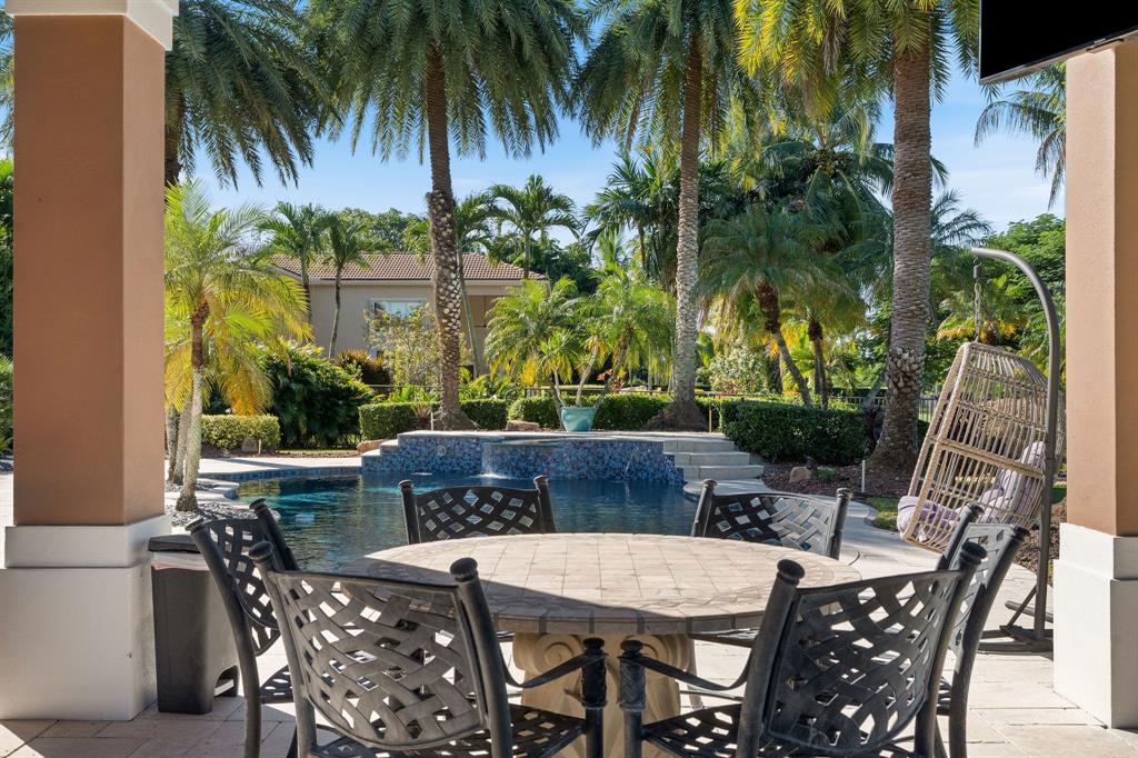 3413 Dovecote Meadow Lane Davie, FL 33328 - Photo 63 of 68 a view of an outdoor space with a table and chairs