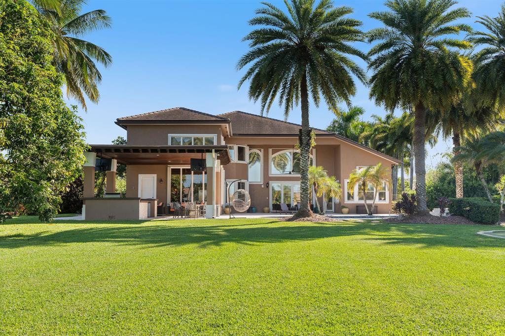 3413 Dovecote Meadow Lane Davie, FL 33328 - Photo 67 of 68 a front view of house with yard and green space