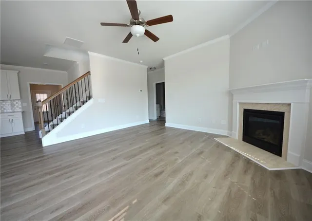 a view of empty room with wooden floor and fireplace