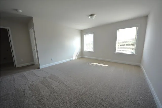 a view of room with stairs and windows