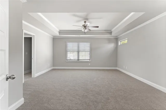 a bathroom with a granite countertop double vanity and a large mirror