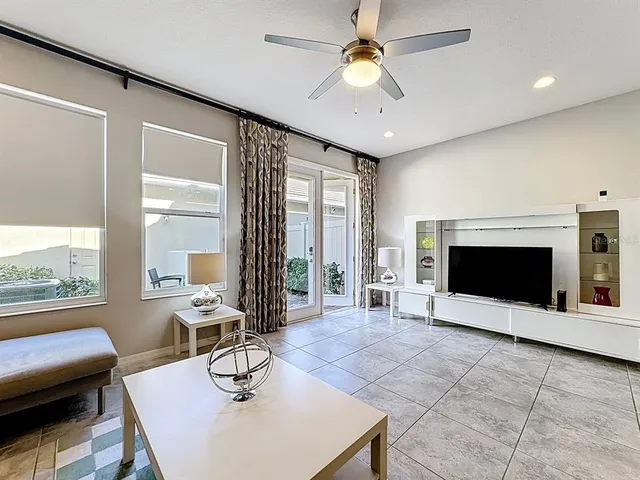 a living room with fireplace furniture and a large window
