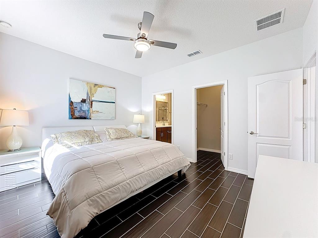 11209 Grander Drive Windermere, FL 34786 - Photo 17 of 35 a bedroom with a bed and wooden floor