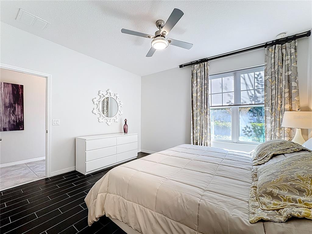 11209 Grander Drive Windermere, FL 34786 - Photo 18 of 35 a bedroom with a large bed and a window