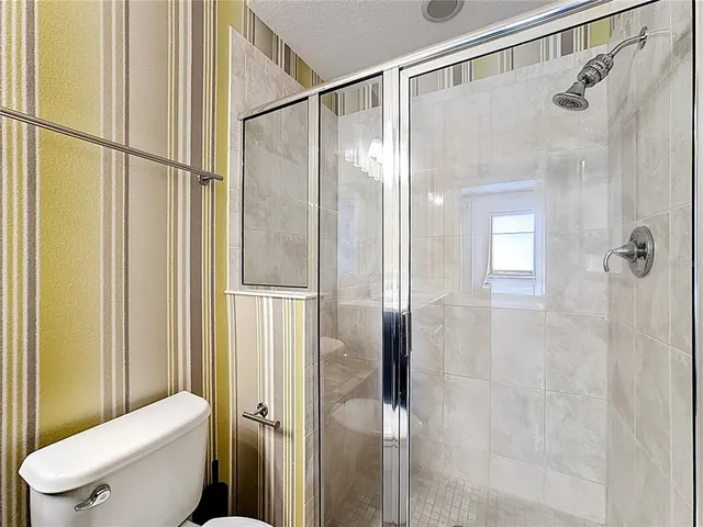 a bathroom with a shower and a toilet