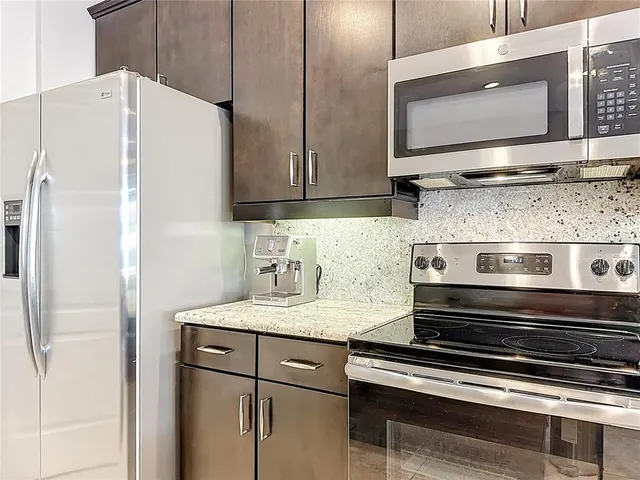 a kitchen with appliances and cabinets