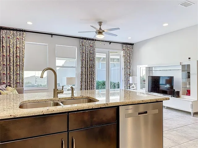 a kitchen with a sink and a large window