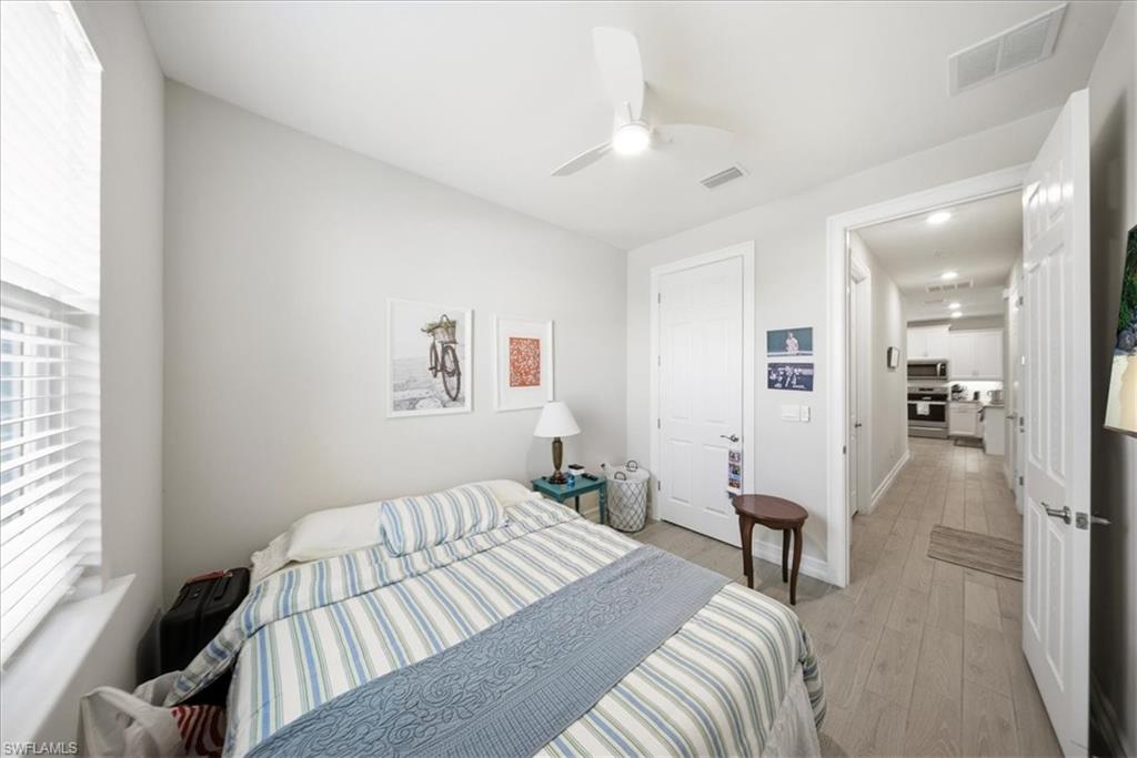 1074 Enbrook Loop Naples, FL 34114 - Photo 11 of 36 a bedroom with a bed and a table