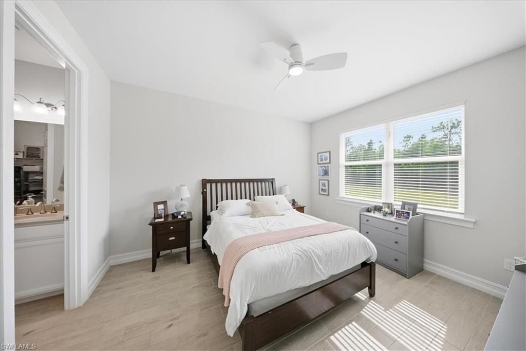 1074 Enbrook Loop Naples, FL 34114 - Photo 17 of 36 a bedroom with a bed and a table