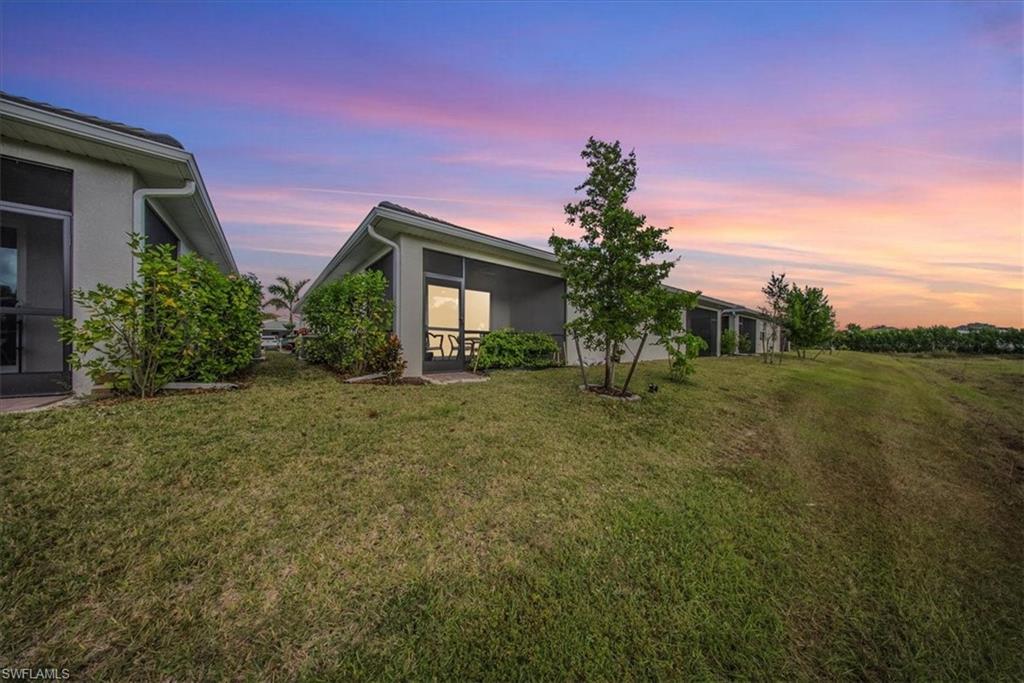 1074 Enbrook Loop Naples, FL 34114 - Photo 2 of 36 a front view of a house with garden