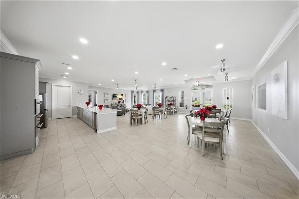 1074 Enbrook Loop Naples, FL 34114 - Photo 28 of 36 a living room with furniture and a view of kitchen appliances